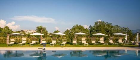 Seasonal outdoor pool, open 10:00 AM to 7:00 PM, pool umbrellas