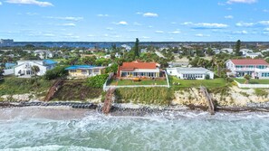 Zona residencial costera con casas, una playa y un litoral rocoso.