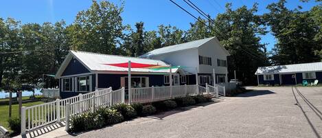 A two-story building with a white exterior and a covered porch.