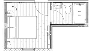 A floor plan of a hotel room with a bed, a small seating area, a bathroom with a shower, and a toilet.