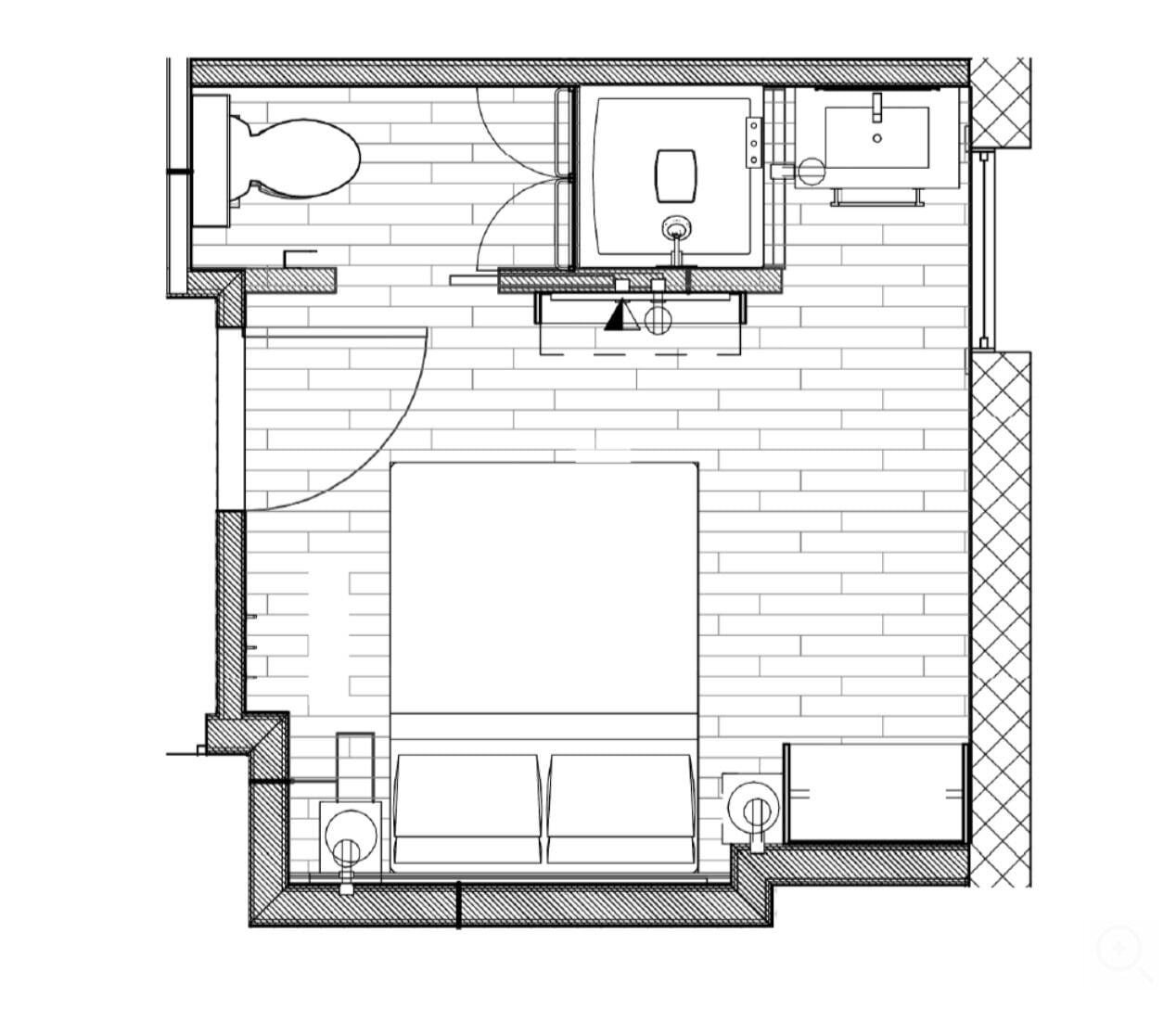 A floor plan of a hotel room with a bathroom, a small kitchenette, and a seating area.