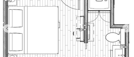 Plano de planta de una habitación de hotel con una cama grande, baño independiente, una pequeña zona de estar y una ventana.