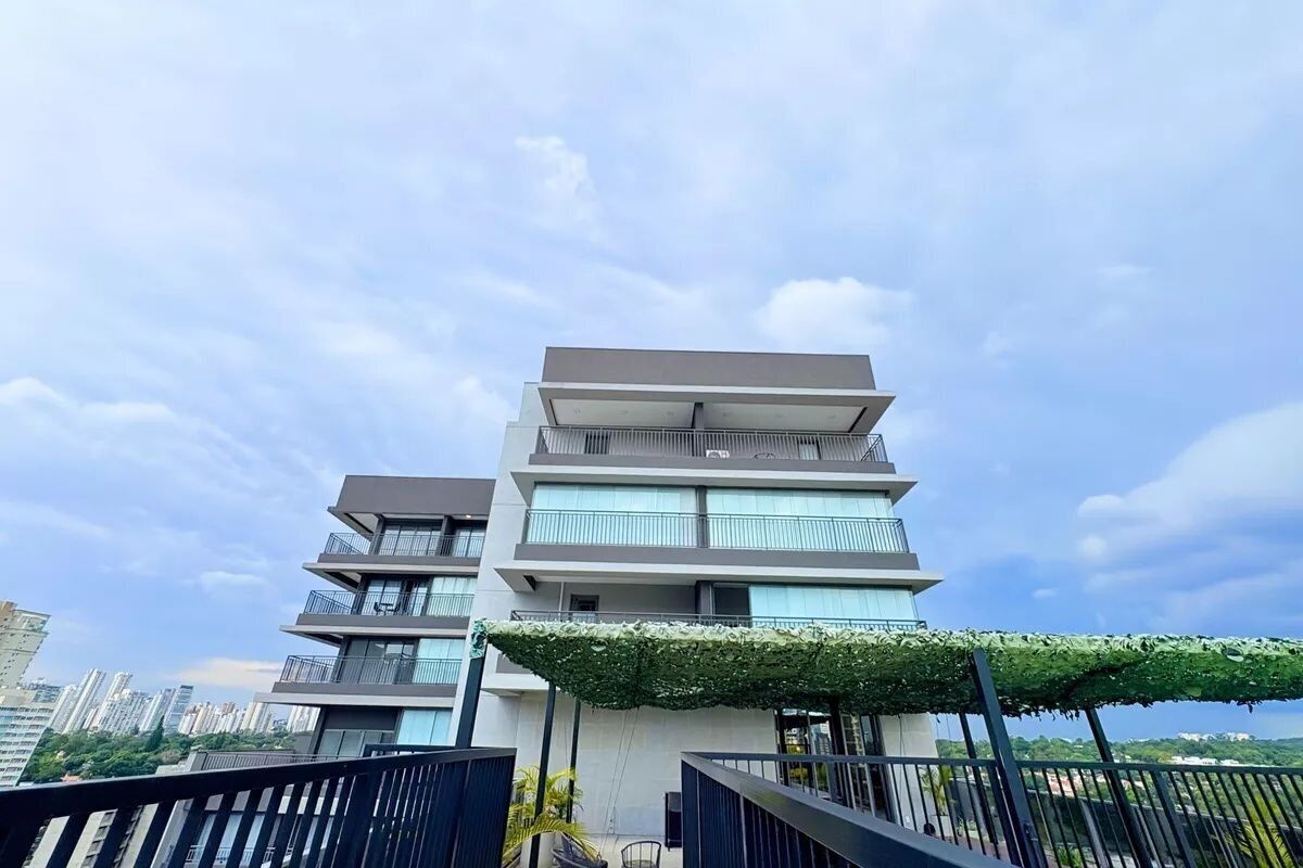 A multi-story building with balconies and a covered outdoor area.