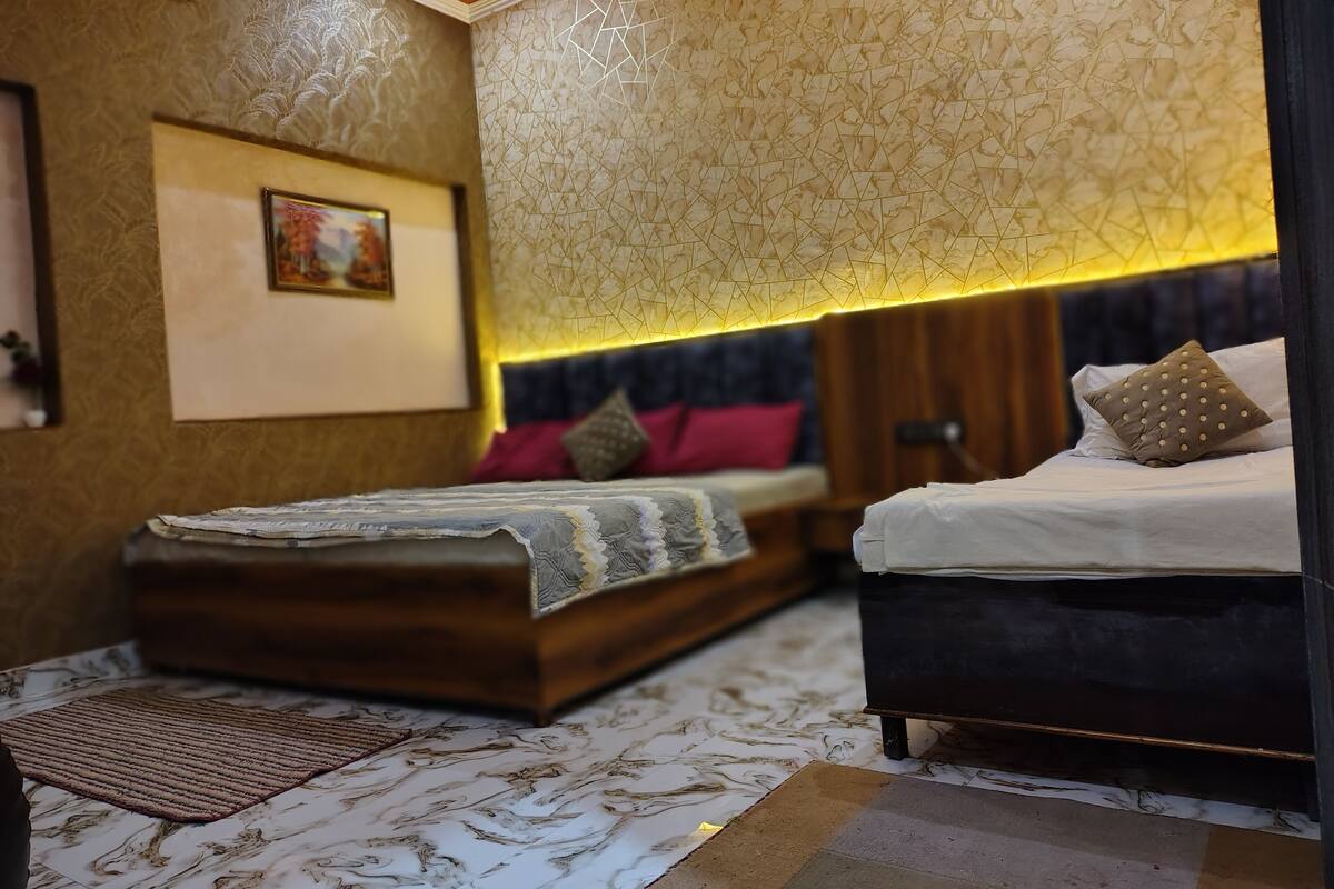 A bedroom with a bed, bedside table, and a wall-mounted artwork.