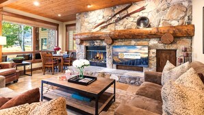 A cozy living area with a stone fireplace, wooden beams, and comfortable seating. - Deer Valley Bct-501 Hot Tub KBM Resorts (Park City)