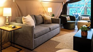 A cozy tented accommodation with a sofa, armchairs, and a small table with a lamp. - Biggest Deck! Beautiful Dome (Pikeville)