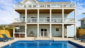 A two-story house with a pool, a covered patio, and a fenced backyard. - 1726 - Beach Sea Sun - Dog-Friendly Corolla Getaway | Pool & Hot Tub (Corolla)