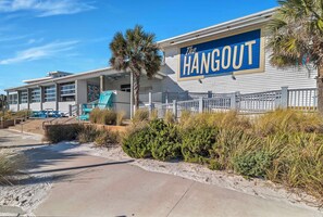 A beachfront building with a sign reading "The Hangout." - Seaview Cottage | Gulf Shores | Walk to The HangOut | My Beach Getaways (Gulf Shores)
