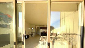 A hotel room with a bed, a desk, and a chair. - Studio w/ King Bed, Ocean Views, Pet Friendly! (Lincoln City)