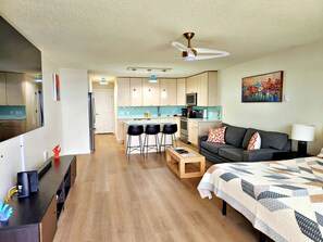 A modern living room with a sofa, a coffee table, and a TV stand.