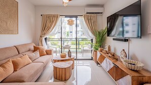 A modern living room with a sofa, coffee table, and TV.