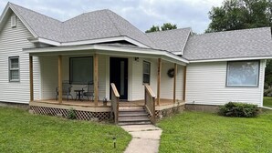 A single-story house with a covered porch, a front door, and a small front yard. - Charming 3-bedroom family friendly home in York (York)