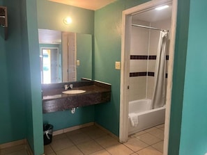 Bathtub, towels, soap, toilet paper