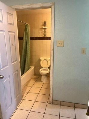 Bathtub, towels, soap, toilet paper