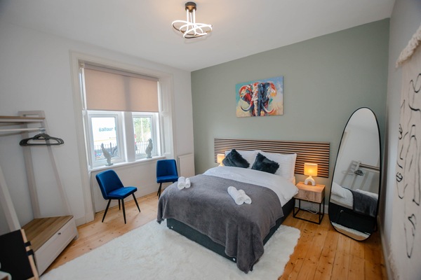 Spacious bedroom with comfortable bed and calming décor