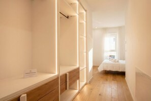 A narrow hallway leading to a bedroom with a bed, a nightstand, and a window with curtains. - Borgo Felice 5 (Cozy Apartment with Balcony) (Bari)
