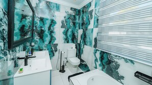 A modern bathroom with a white sink, toilet, and bathtub. - Mawo Luxury Boutique (Johannesburg)