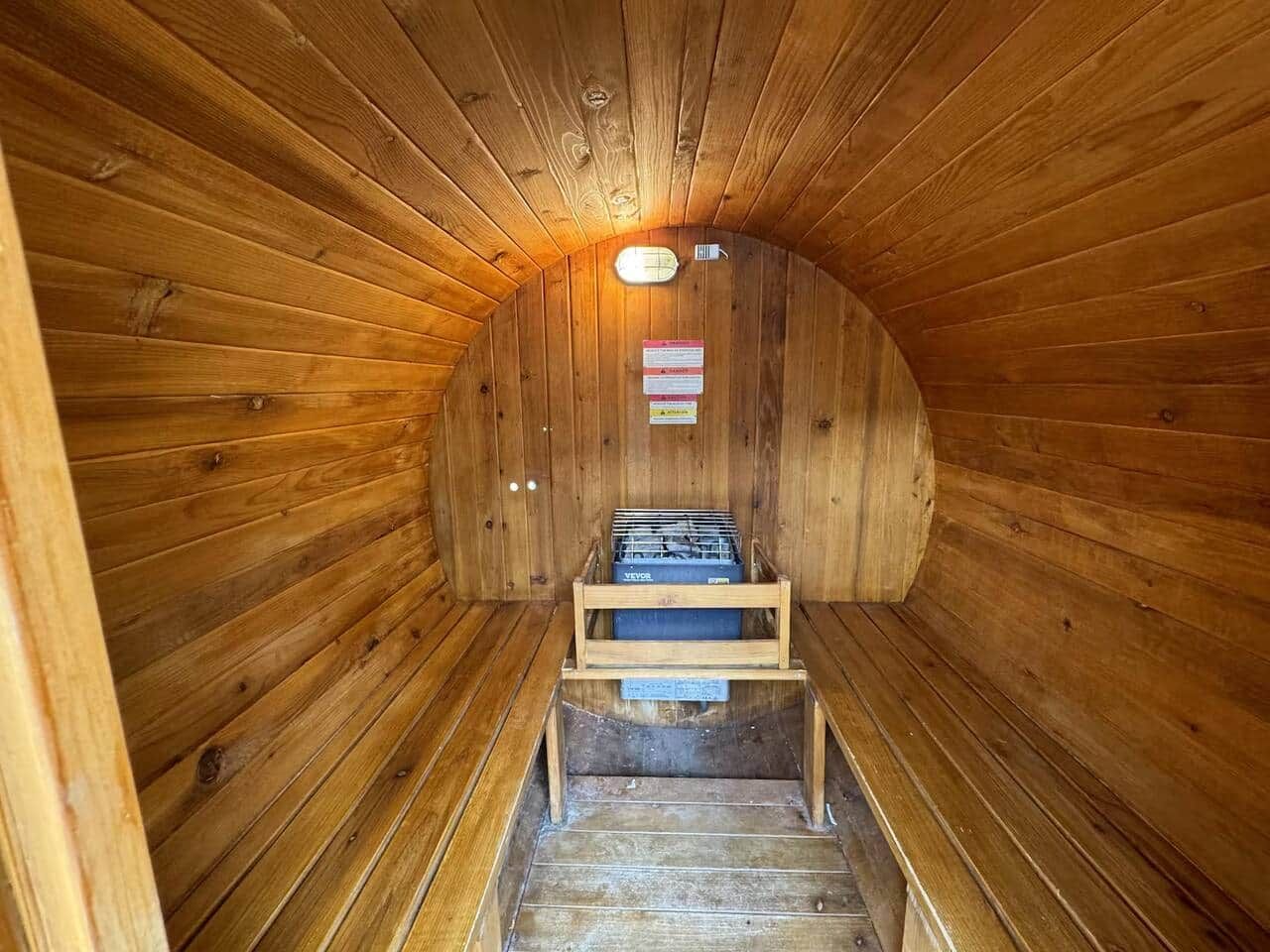 A sauna with wooden walls and a bench.