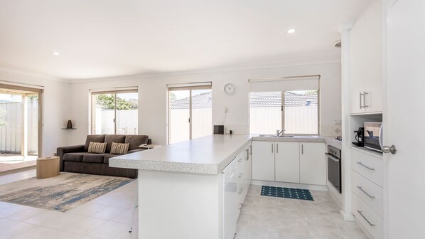 Microwave, oven, toaster, dining tables
