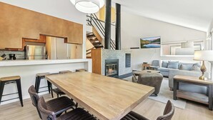 A modern living space with a kitchen, dining area, and seating area.