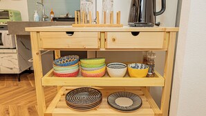 A kitchen counter with a coffee maker, a toaster, and various bowls and plates. - Designer-style 2-bedroom apartment & large living room Max 7people Shinjuku 501 (新宿区)