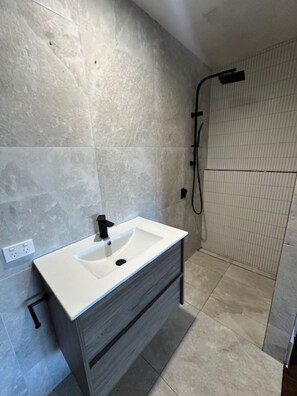 Shower, hair dryer, towels, toilet paper