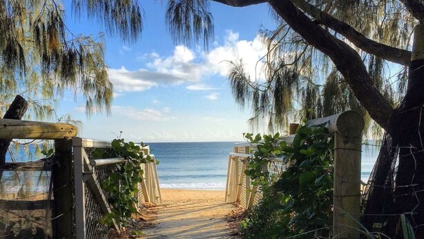 A wooden pathway leading to a beach with a clear view of the ocean. - Beachfront Location -Ground Floor. Listen to the waves! (Mooloolaba)
