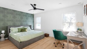 Ein modernes Schlafzimmer mit einem Bett, einem Schreibtisch und einem Stuhl.