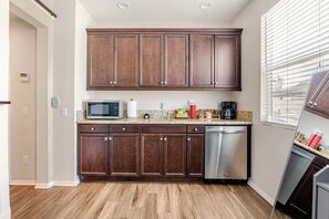 Fridge, microwave, coffee/tea maker, cookware/dishes/utensils