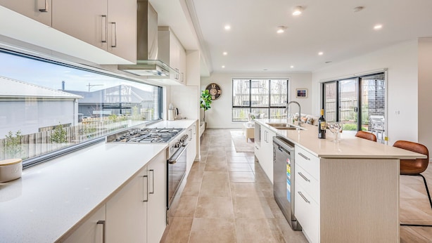 A modern kitchen with a central island, a large window, and a view of the outside. - StayAU 5BR Family Getaway GreaterGeelong in Duneed (Mount Duneed)