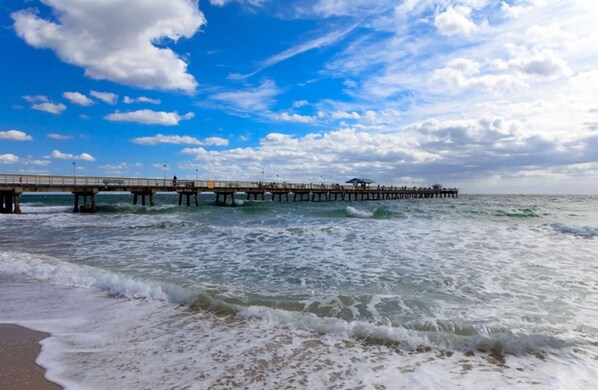 A pier extending into the ocean with a clear sky above. - Tropical Pier-Close Pool Retreat (Pompano Beach)