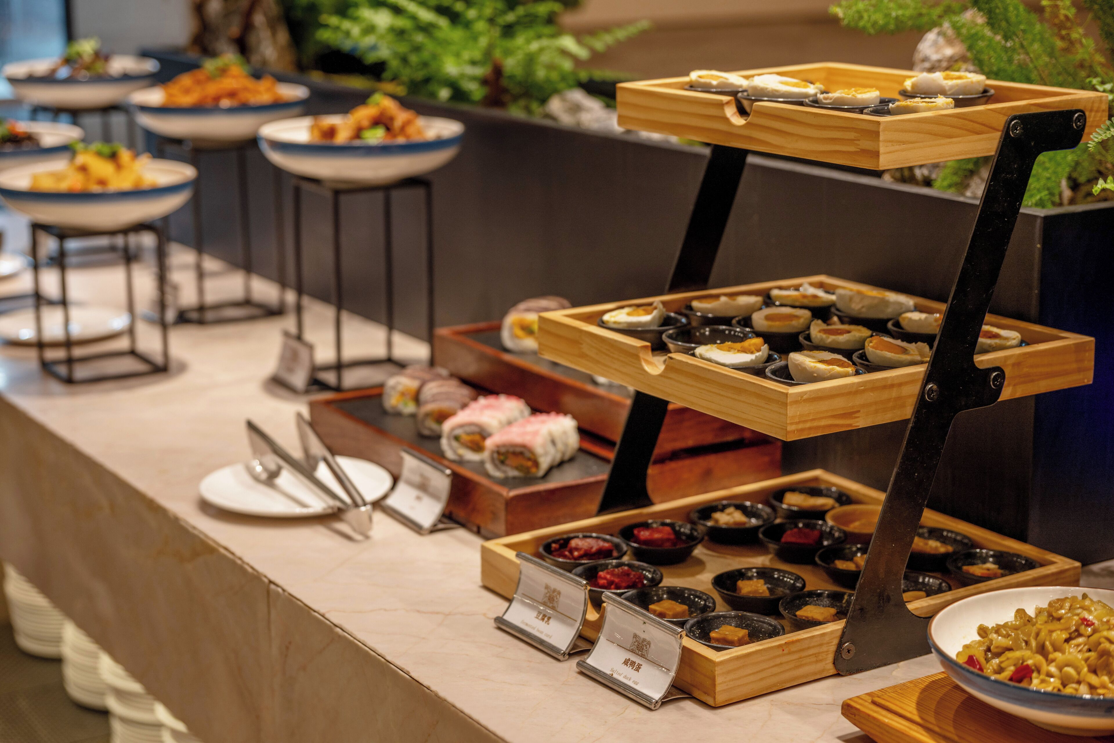 A buffet with various dishes and condiments.