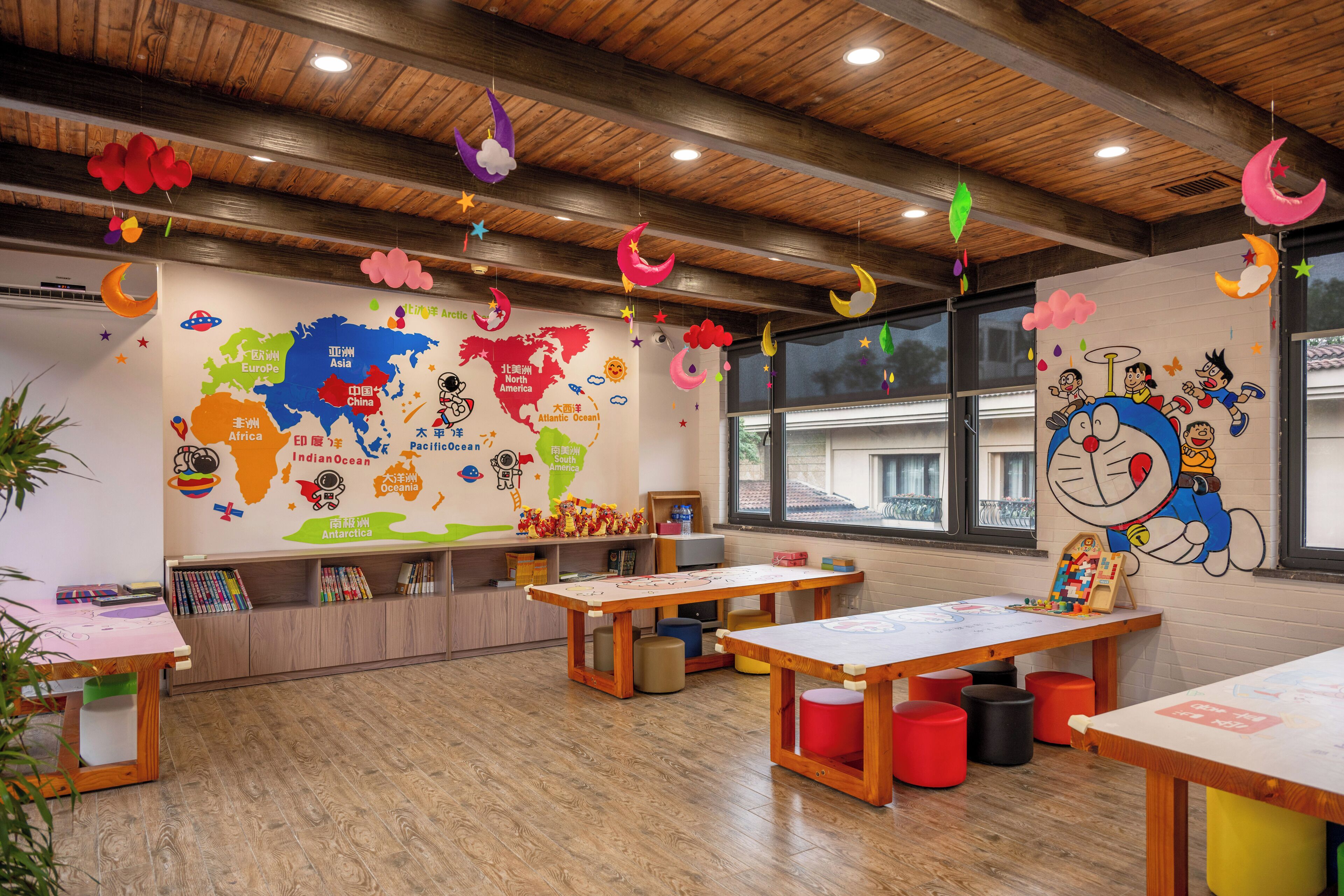A classroom with a world map, educational materials, and playful decorations.