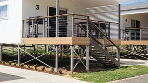 A modern two-story building with a covered outdoor area, numbered 3 and 4, and a staircase leading to the upper level. - Bridgewater Caravan Park (Bridgewater on Loddon)