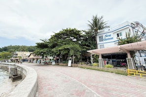 A waterfront promenade with a building labeled "Sea Queen" and a concrete staircase leading to a dock. - Sea Queen Dive Resort Puerto Galera (Puerto Galera)