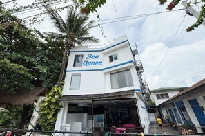 A two-story building with a sign reading "Sea Queen."