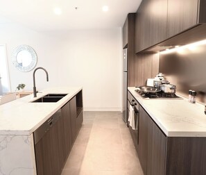Fridge, microwave, oven, stovetop - Olympic Park Stylish 2BR | Walk to stadium | Pool & Gym (Lidcombe)