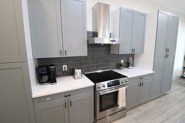 Fridge, stovetop, dishwasher, coffee/tea maker