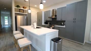 Fridge, stovetop, dishwasher, coffee/tea maker