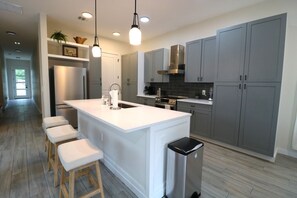 Fridge, stovetop, dishwasher, coffee/tea maker