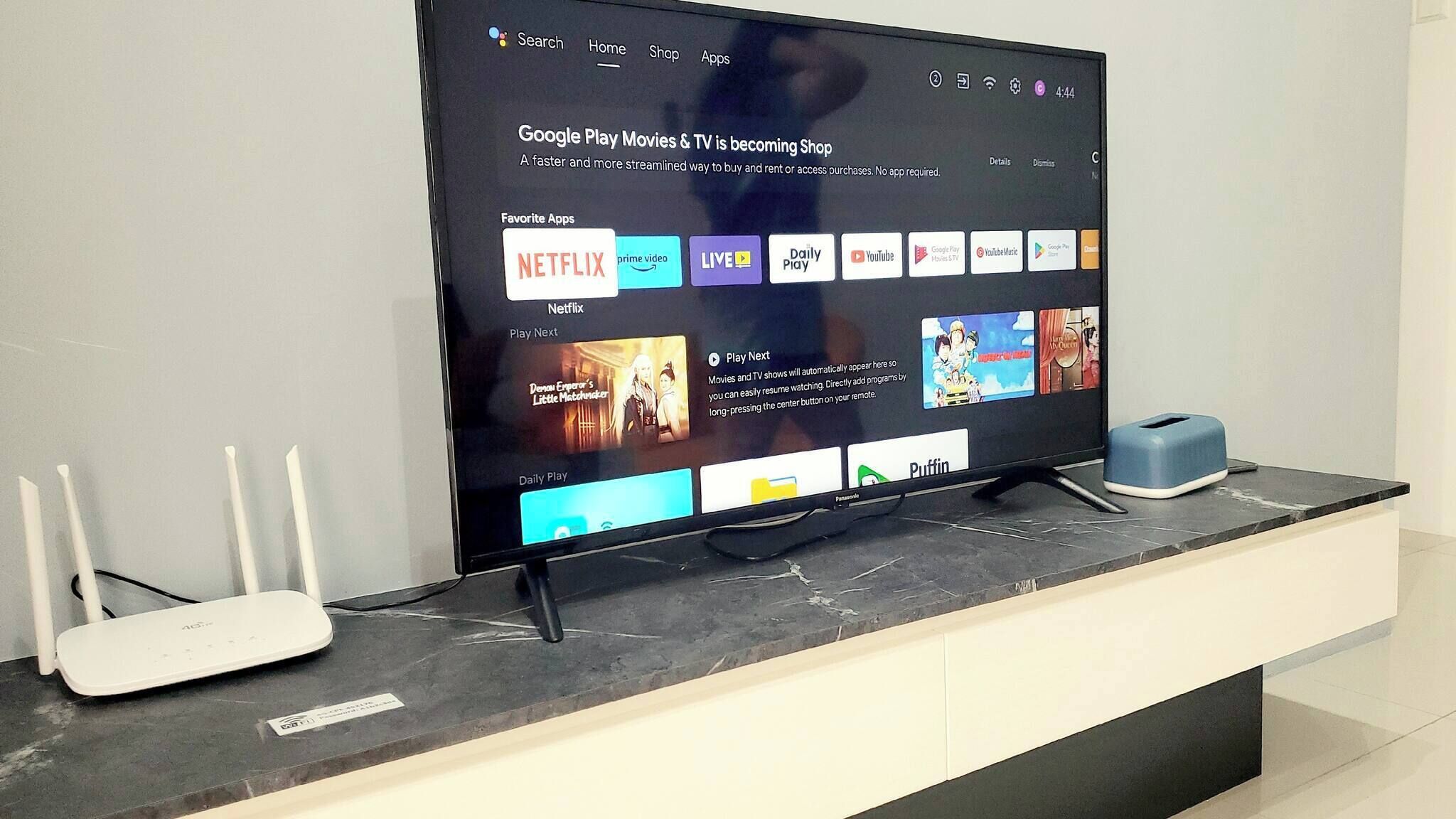 A television displaying a Google Play Movies & TV interface with various streaming apps.