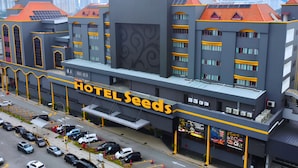 Ein mehrstöckiges Hotel mit einem auffälligen Schild, auf dem 'HOTEL SEEDS' steht.
