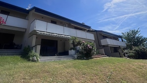 Un bâtiment moderne à deux étages, doté d’un toit plat, de grandes fenêtres et d’un espace d’entrée abrité.