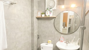 A bathroom with a toilet, sink, and shower. There is a mirror above the sink and a towel rack on the wall. - Cozy studio with washing machine & dryer in the heart of Hà Nội (Hà Nội)