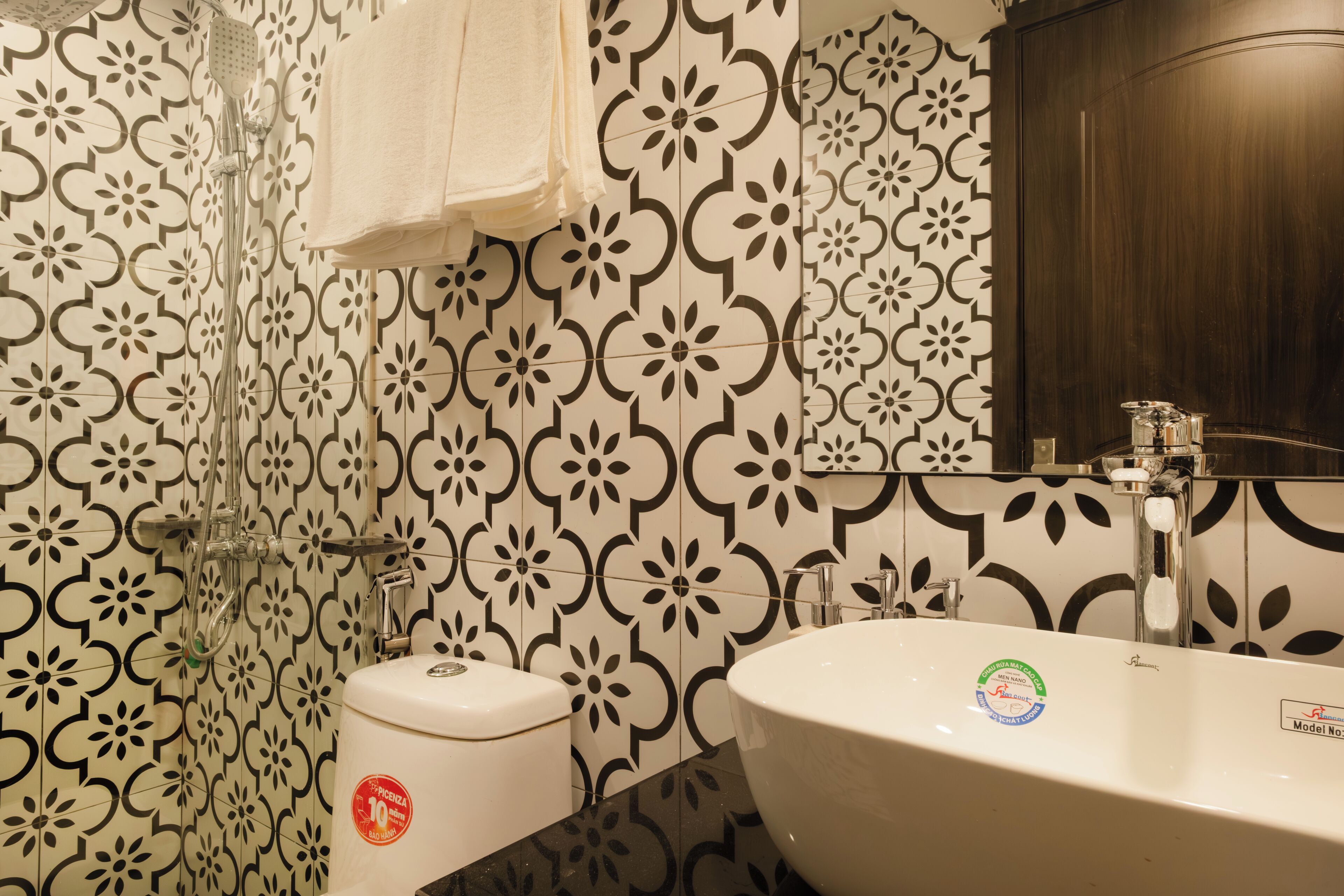 A bathroom with a white sink, a toilet, and a shower with a glass door.