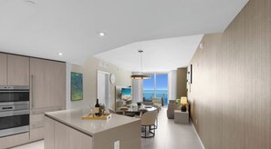 A modern kitchen with a central island, a dining area with a view, and a living space with a large window.