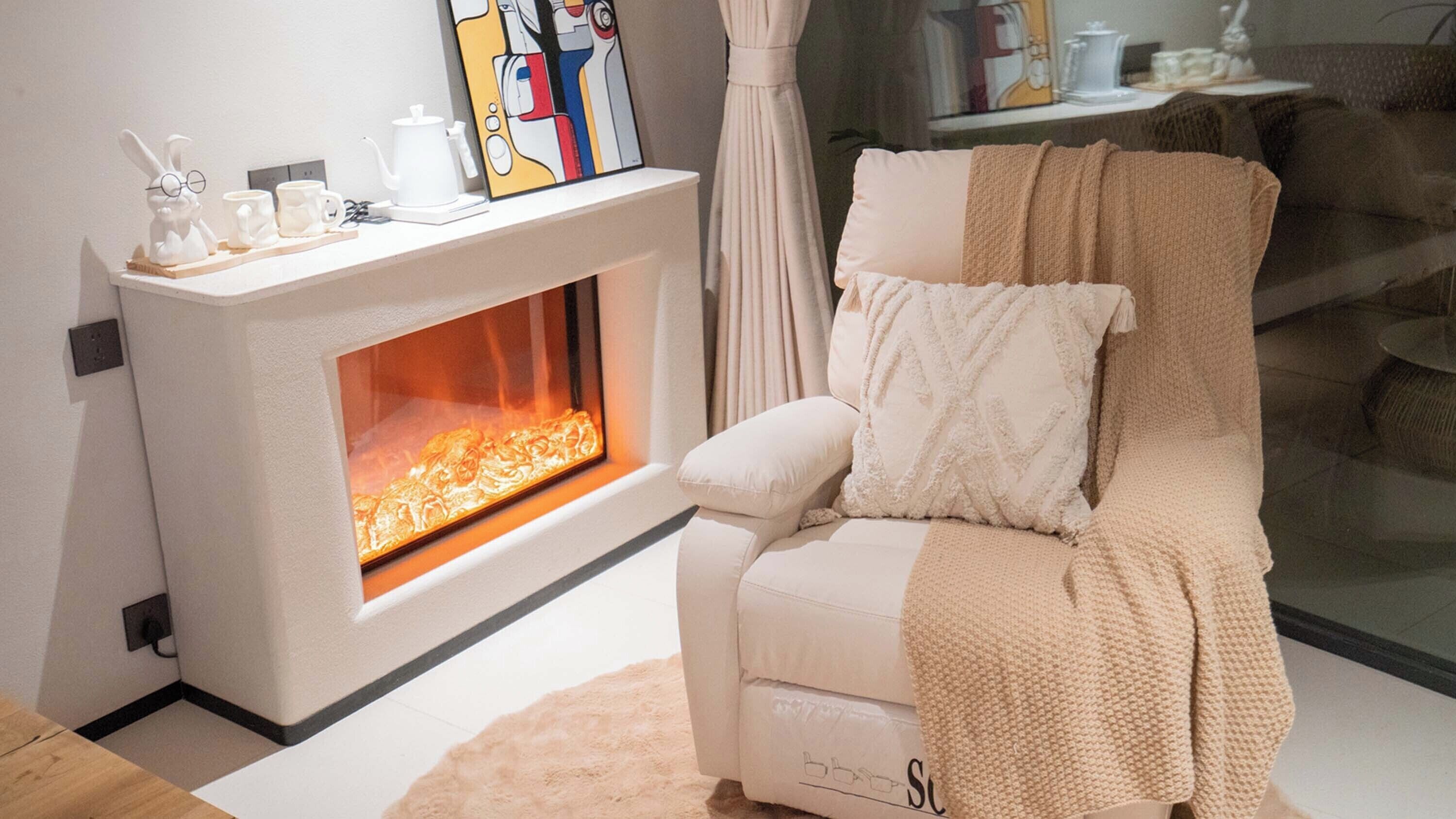 A modern living room with a fireplace, a white armchair, and a coffee table.
