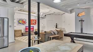 A modern living room with a pool table, a sofa, and a dining table. - Inman Park Terrace Suite w/ Private Entrance (Atlanta)