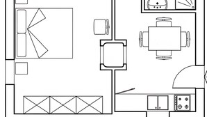 A floor plan with a dining area, kitchen, and a bathroom.
