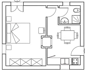 Plano de planta que muestra un comedor, una cocina y un baño.